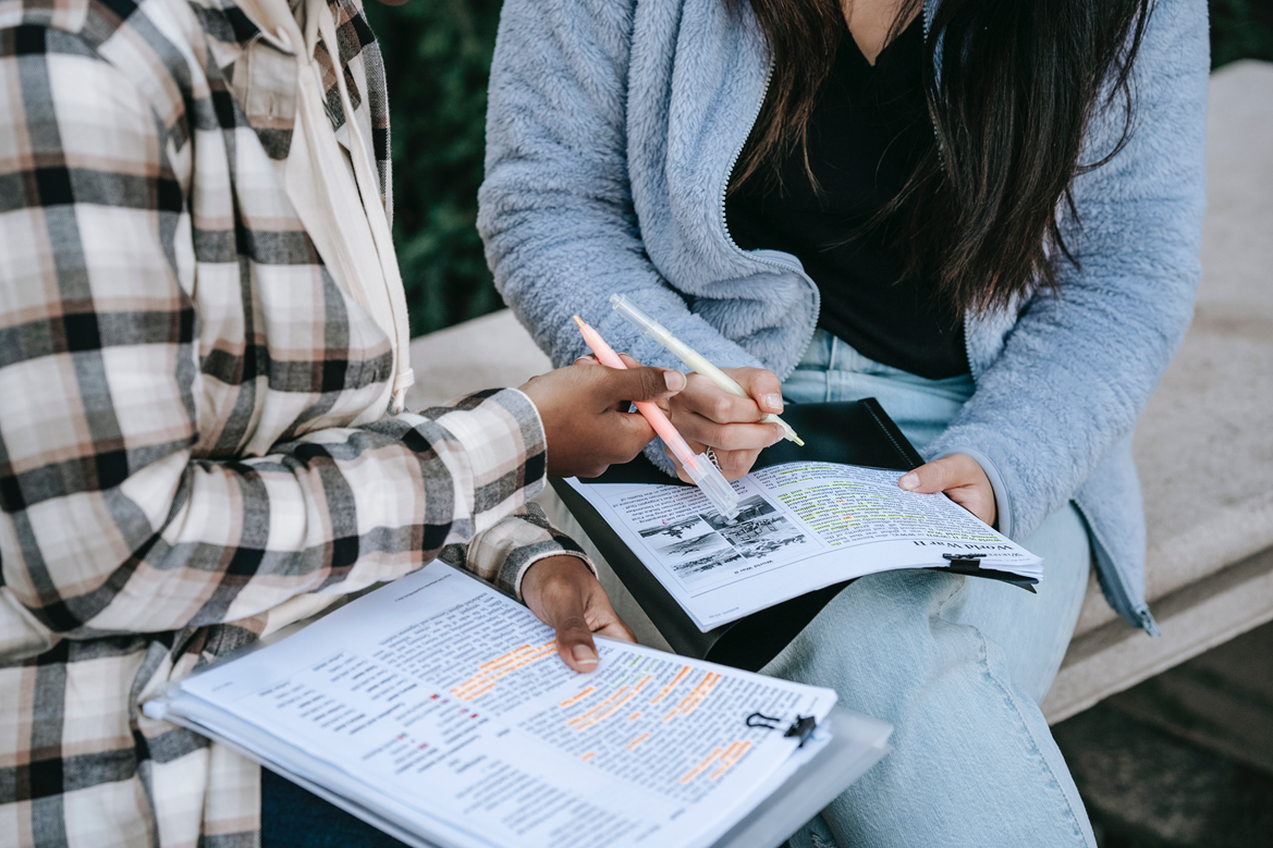 two women doing classwork without computers..
